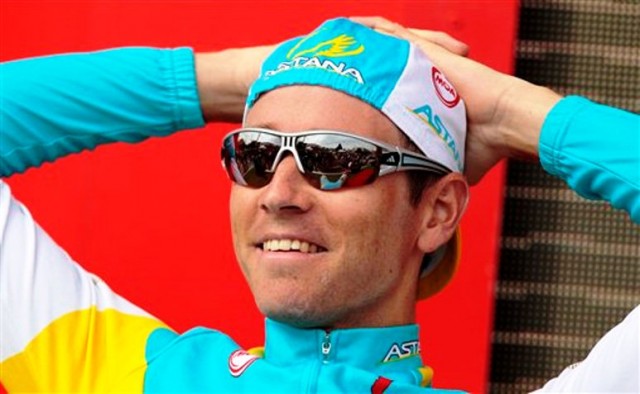 Swedish rider Fredrik Kessiakoff smiles on the podium after winning the 11th stage time trial in Pontevedra, Spain Wednesday Aug. 29, 2012. The 21-stage, three week race ends in Madrid on Sept. 9. (AP Photo/Lalo R. Villar)